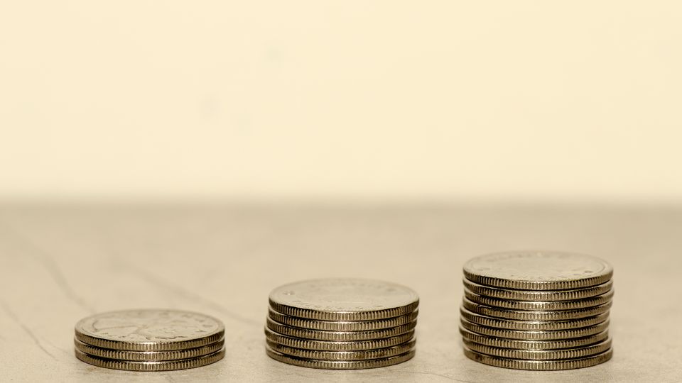 Three stacks of coins, each taller than the last