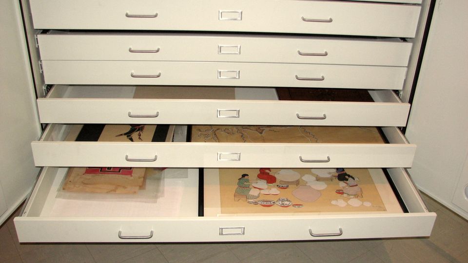 Wide flat-file drawers pulled open in an archive
