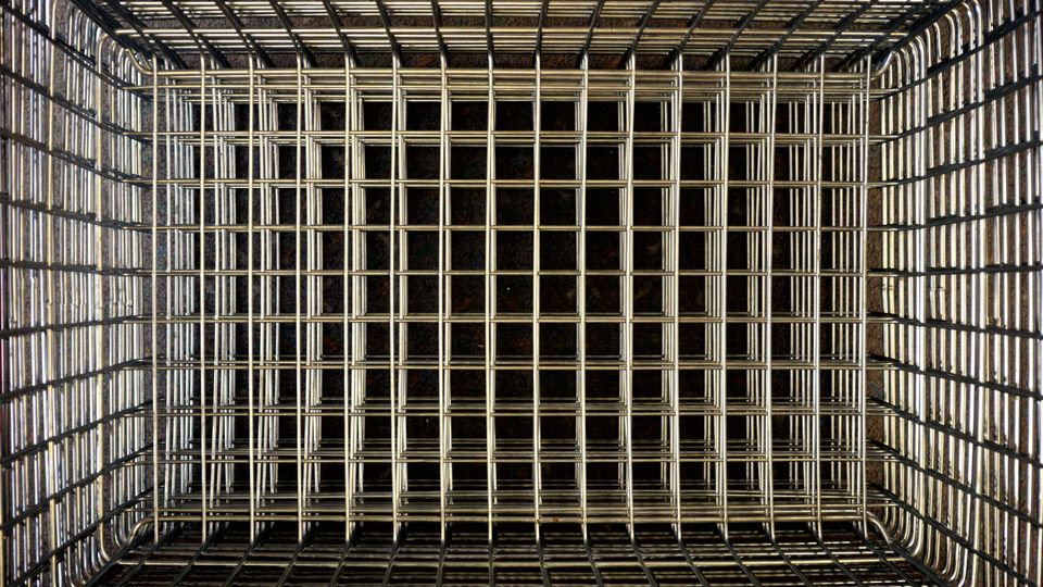 An empty wire shopping basket seen from above