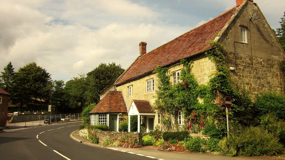 A stone cottage beside a country road
