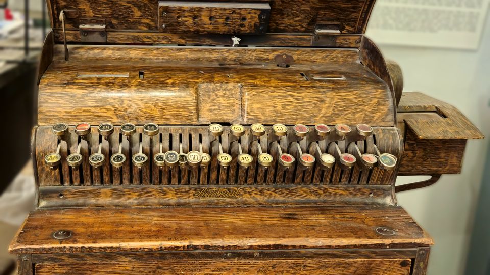An ornate antique brass cash register