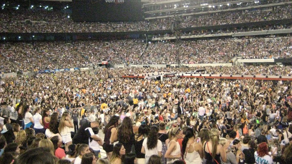 A packed stadium crowd seen from the stands