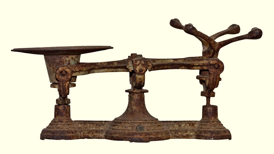 An antique cast-iron weighing scale