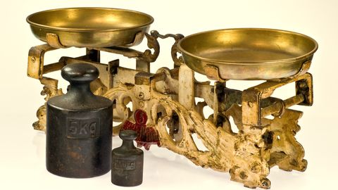 An antique brass balance scale with weights