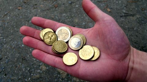 Coins resting in an open palm