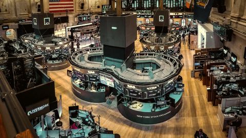 Overhead view of a stock exchange trading floor with rows of screens