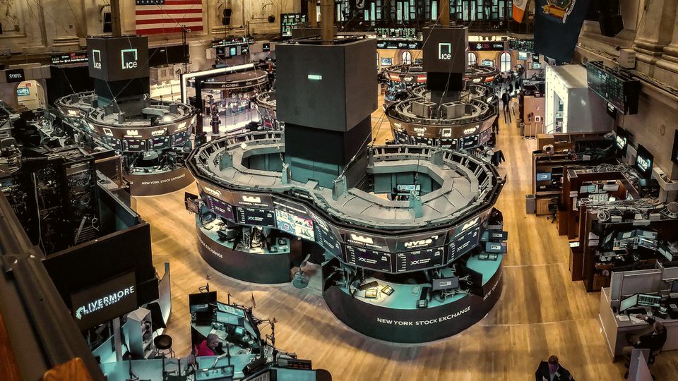 Overhead view of a stock exchange trading floor with rows of screens