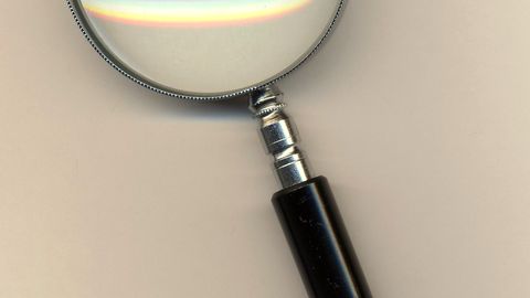 A magnifying glass lying on a plain surface